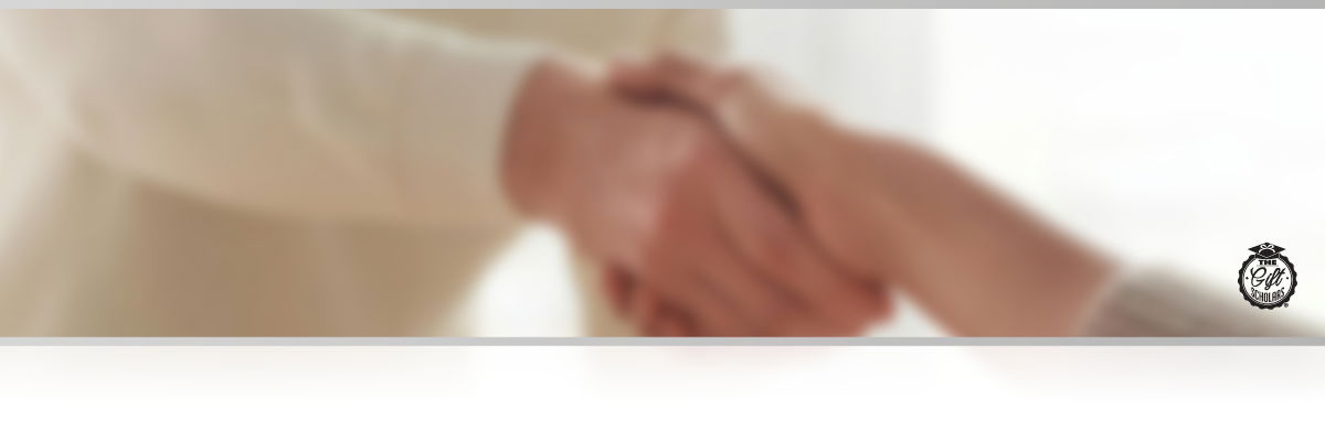 Blurred image of two people shaking hands in an office environment