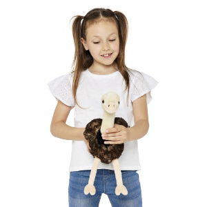 Kid playing with an Ostrich plush against a white background