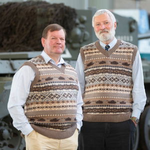 two men wearing sleeveless jumpers with tank patterns on them